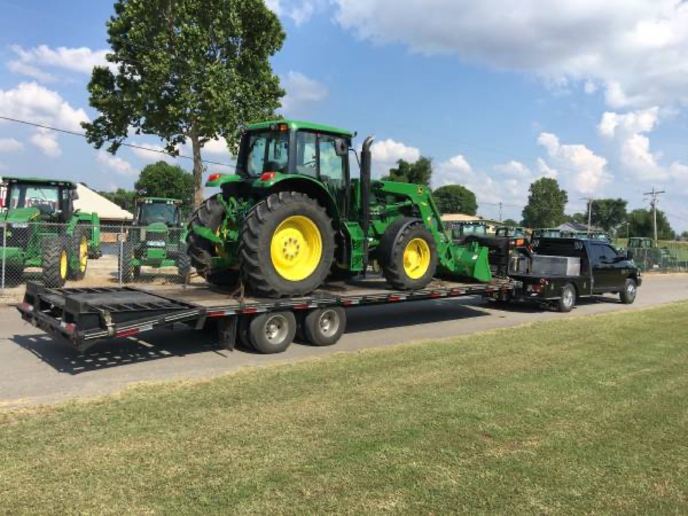 John Deere tractor loaded on a trailer for delivery by ClearYard Tractor